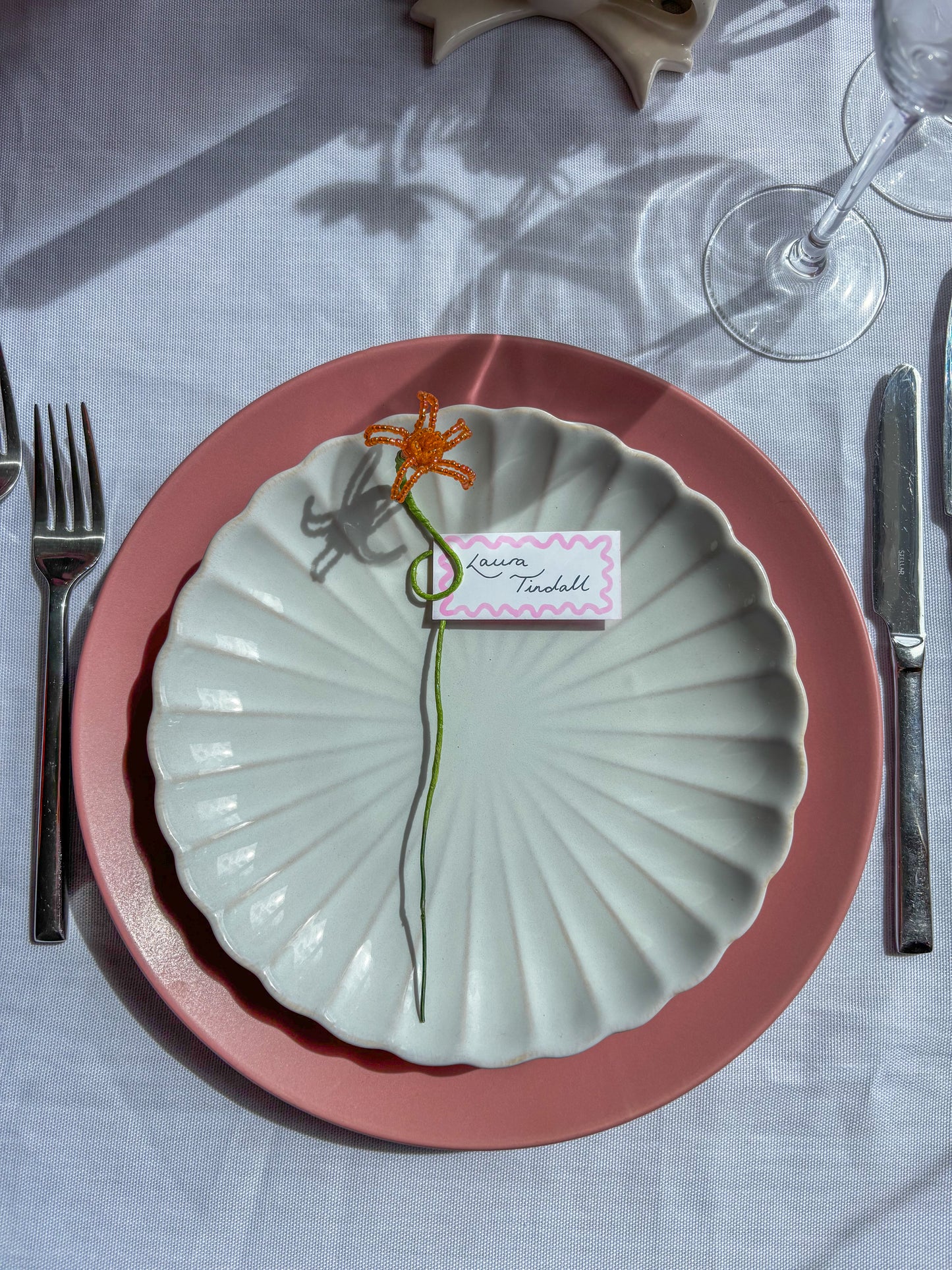 Floral place card holder at a wedding in scene 